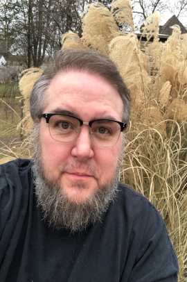 michael munson standing in front of fall grass